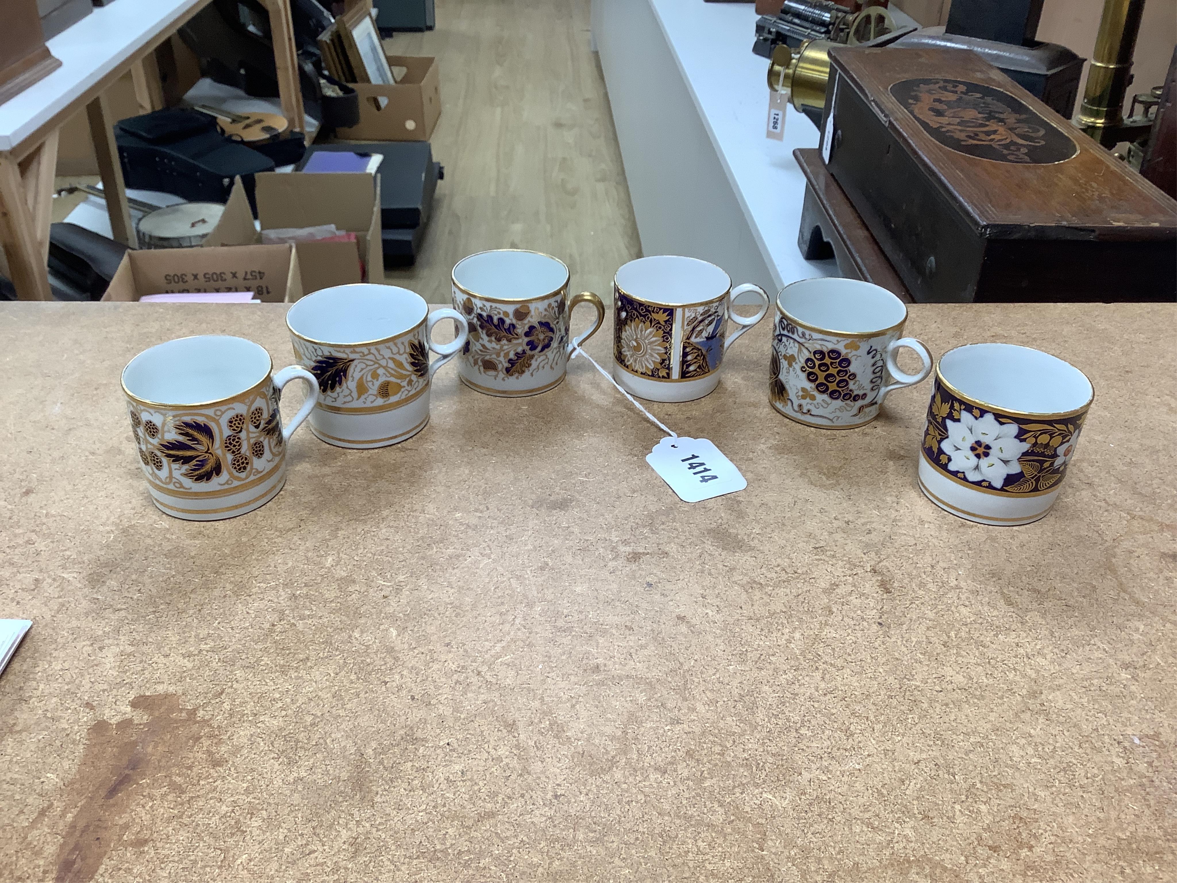 Twelve 1800-1820 English porcelain, mostly blue and gilt decorated coffee cans